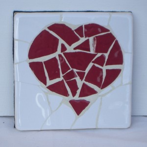 Mopsaic coaster with a red heart shaped motif.