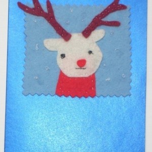 Handmade Christmas greeting card with a felt reindeer