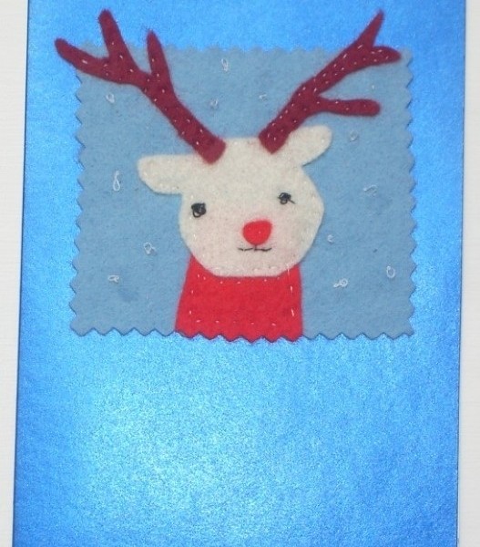 Handmade Christmas greeting card with a felt reindeer